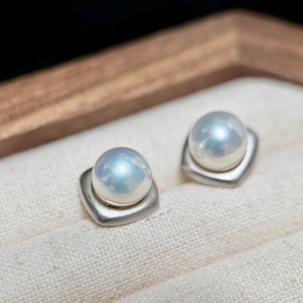 Minimalist 8.8 mm blue-halo freshwater pearl stud earrings in frosted sterling silver.
