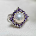 Purple zirconia flower ring with luminous natural freshwater pearl.