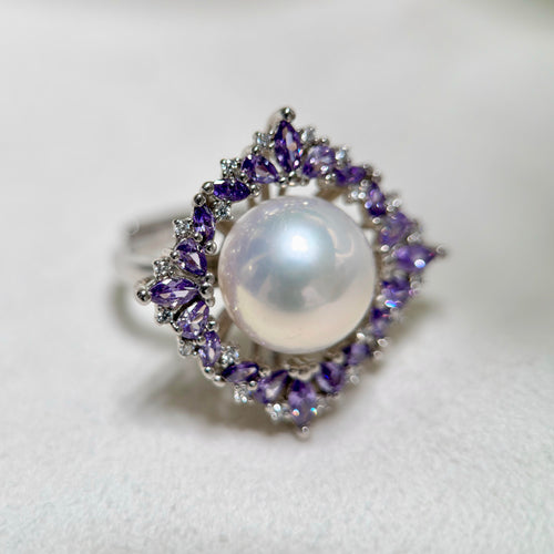 Purple zirconia flower ring with luminous natural freshwater pearl.