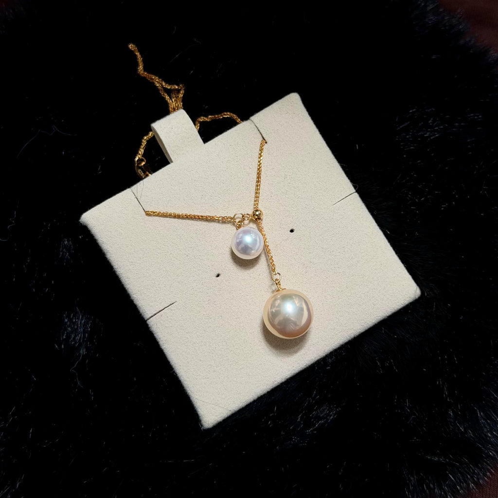 Double freshwater pearl necklace featuring contrasting creamy golden and white pearls.