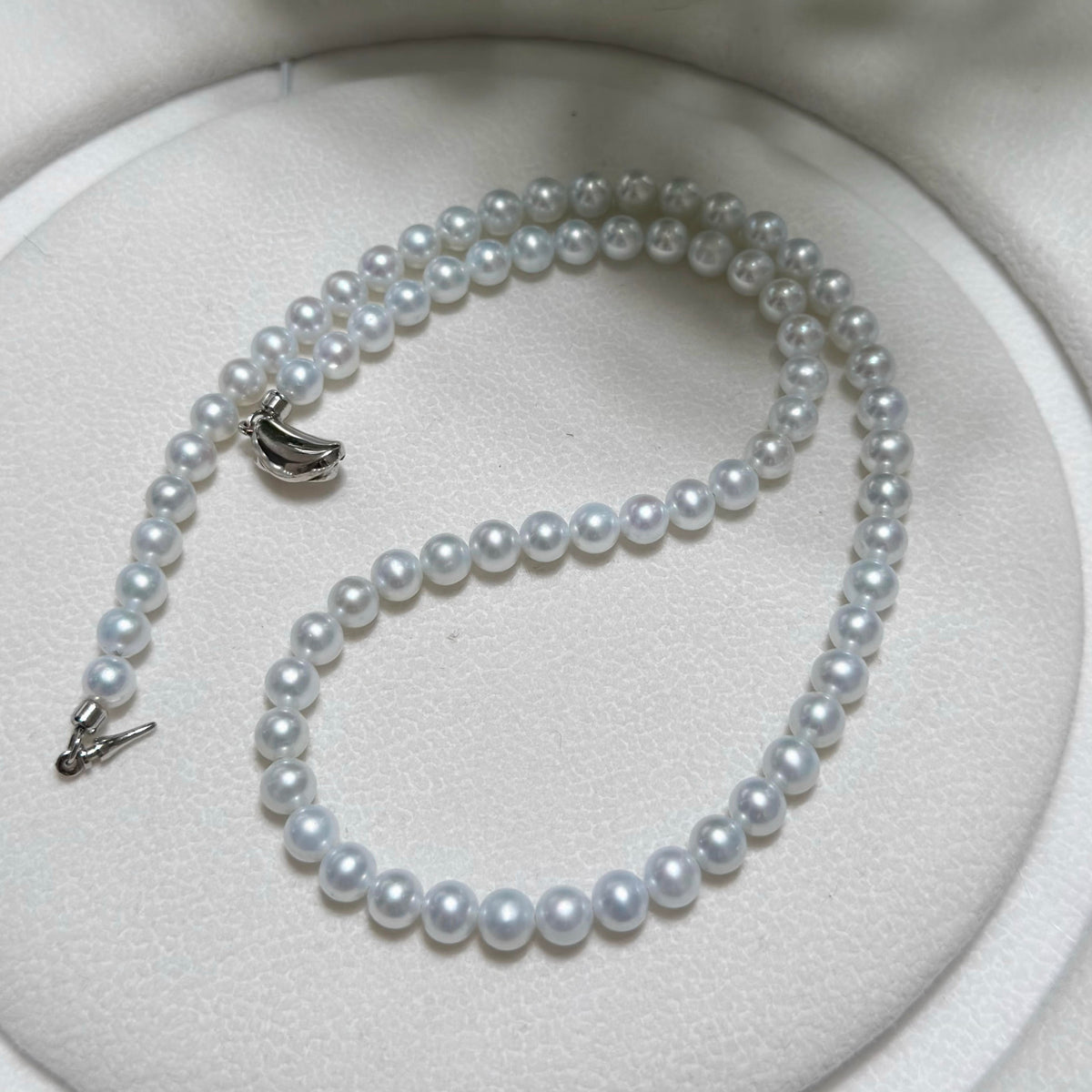 Close view of cold-blue freshwater pearls with bright mirror-like lustre.
