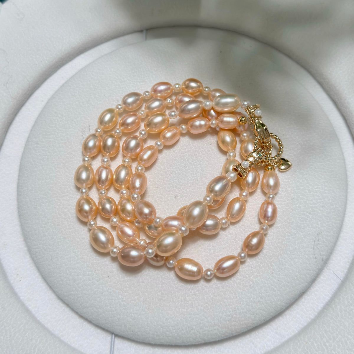 Close-up of oval freshwater pearls with golden-orange natural colour.