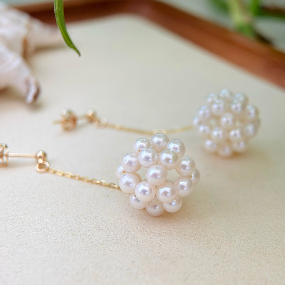 Floral pearl dangle earrings featuring clustered hydrangea-style blooms.