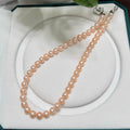 Peach-orange natural pearl strand with warm luminous colour.

