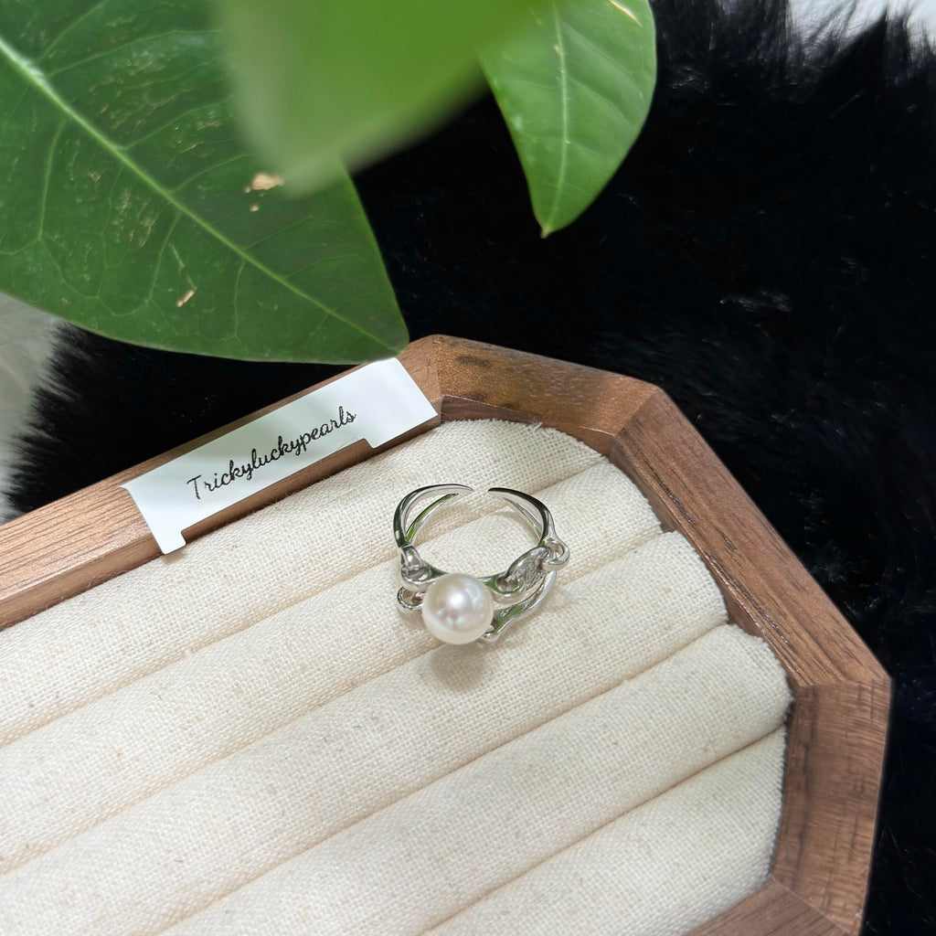 Modern white freshwater pearl ring with open adjustable band.