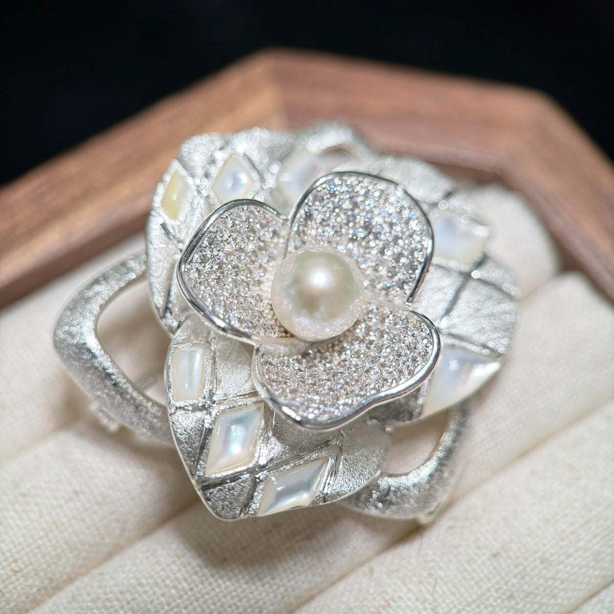 White freshwater pearl brooch with detailed sculptural floral styling.