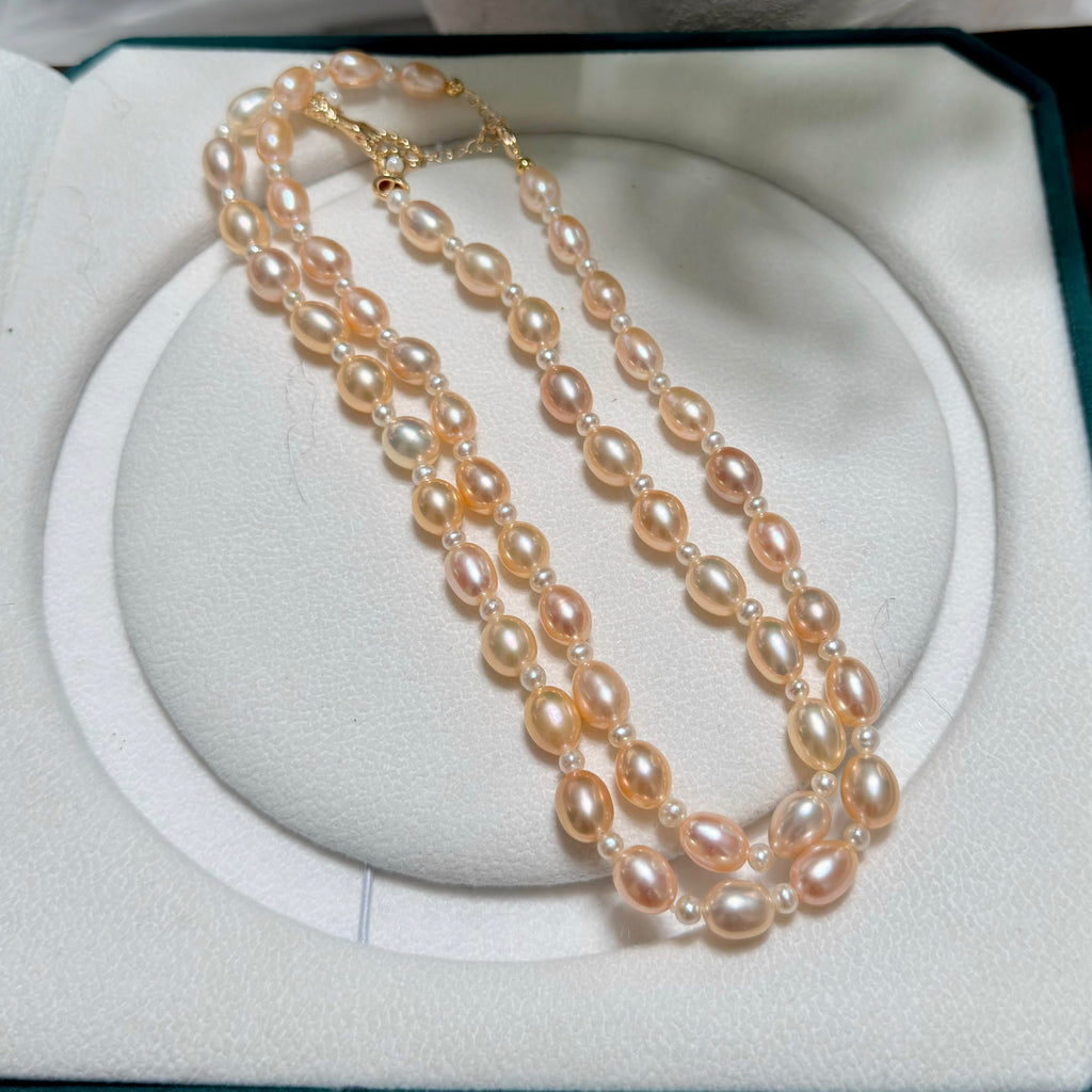 Long golden pearl necklace with adjustable extender chain.