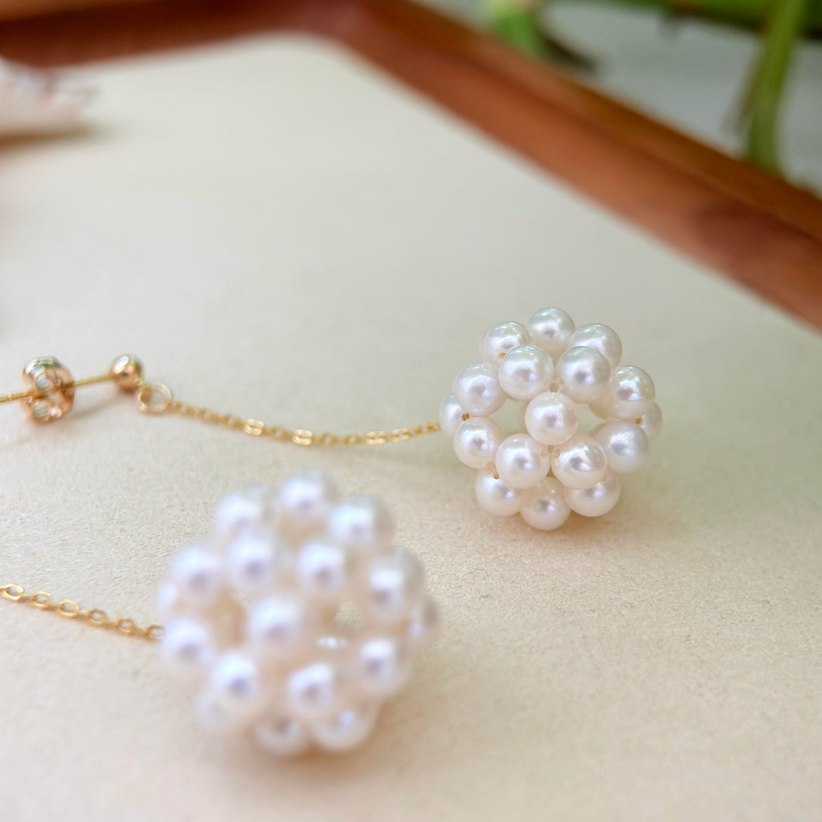 White freshwater pearls arranged into delicate flower-shaped earrings.