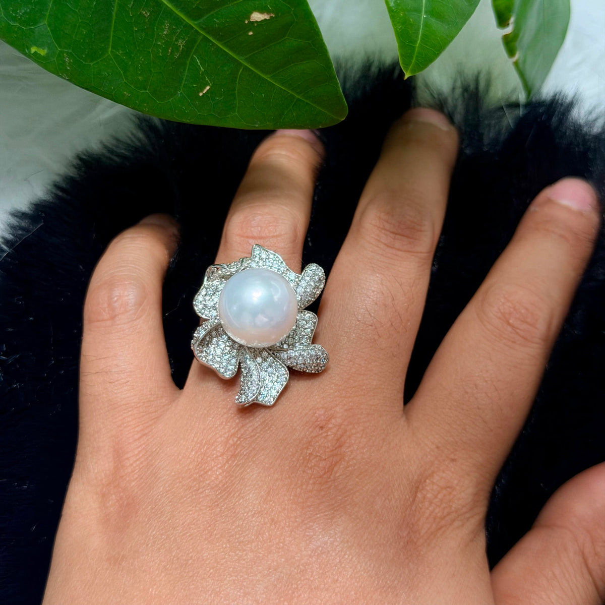 White pearl ring displaying a soft pink iridescent overtone.