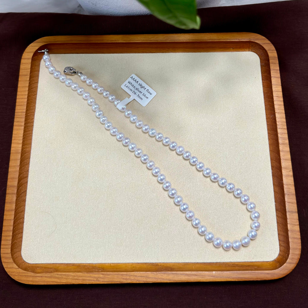 Cool white with blue-silver iridescence freshwater pearl strand with 6–7 mm pearls.