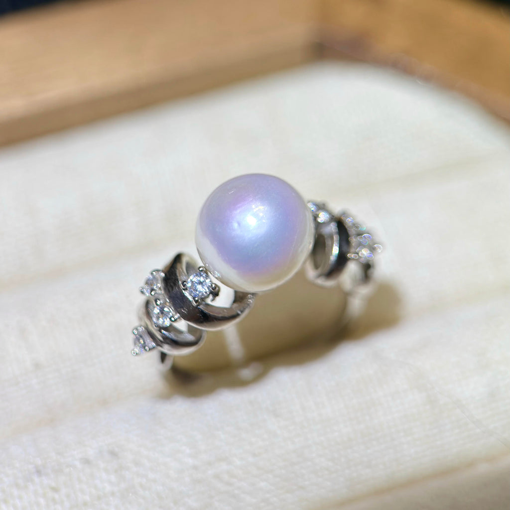 White pearl ring with vivid blue and pink iridescent overtones.