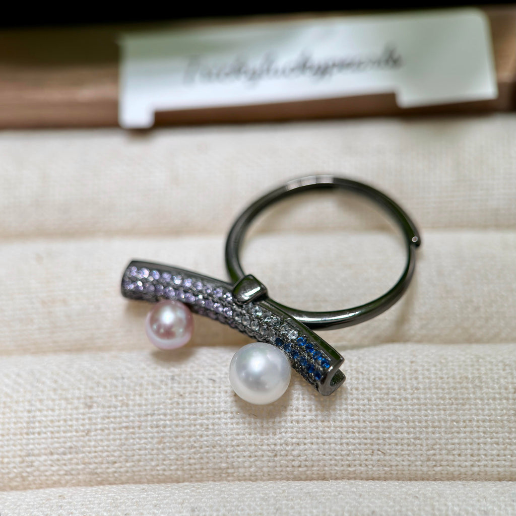 Sterling silver seesaw pearl ring with adjustable open band.