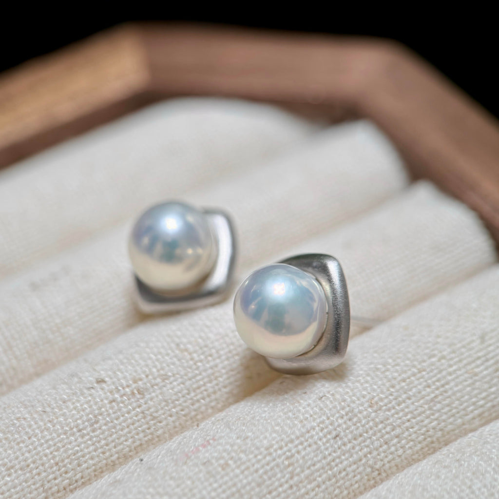 Blue halo pearl earrings with a soft matte 925 sterling silver setting.
