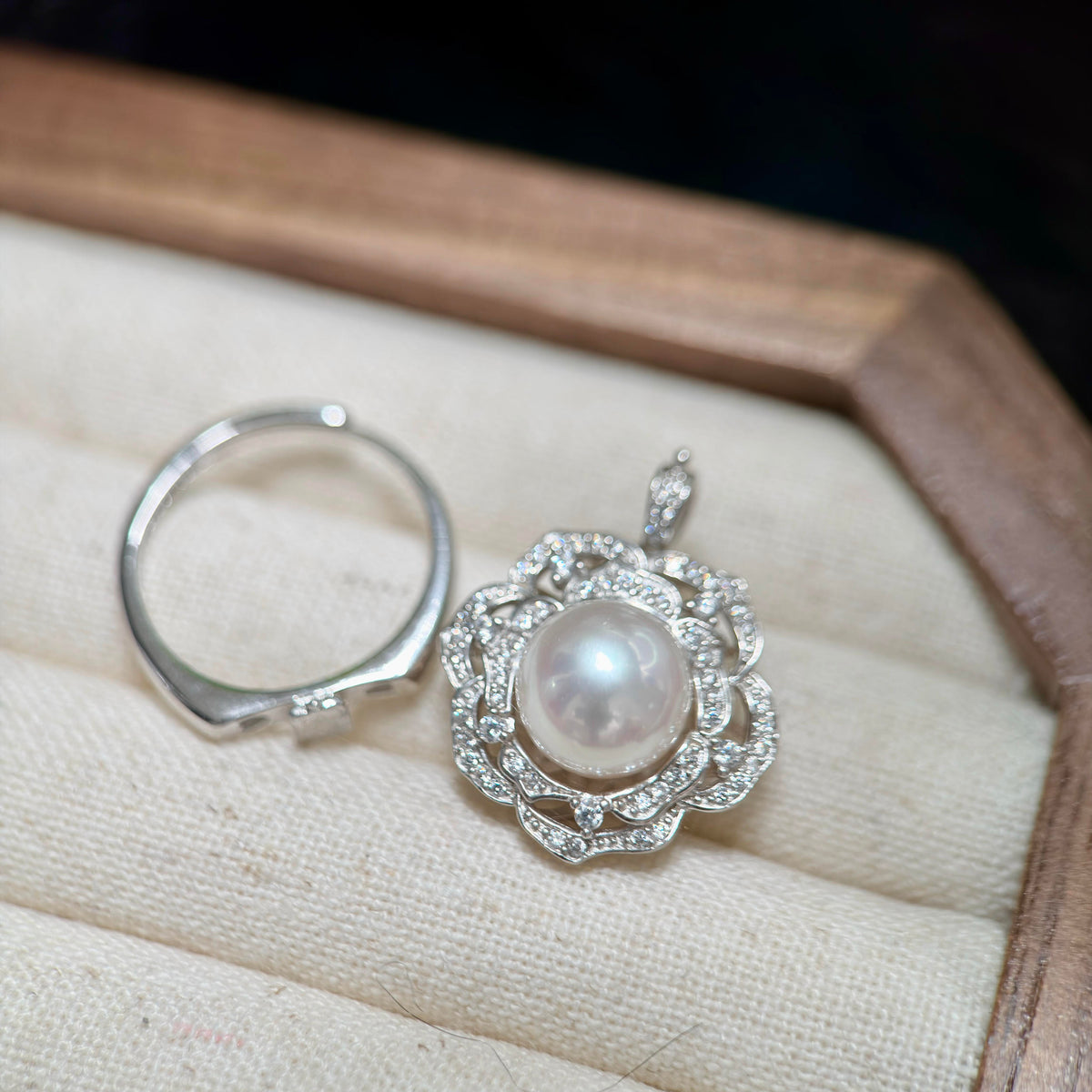 Convertible 2-in-1 camellia pearl ring and pendant with a 10 mm freshwater pearl.