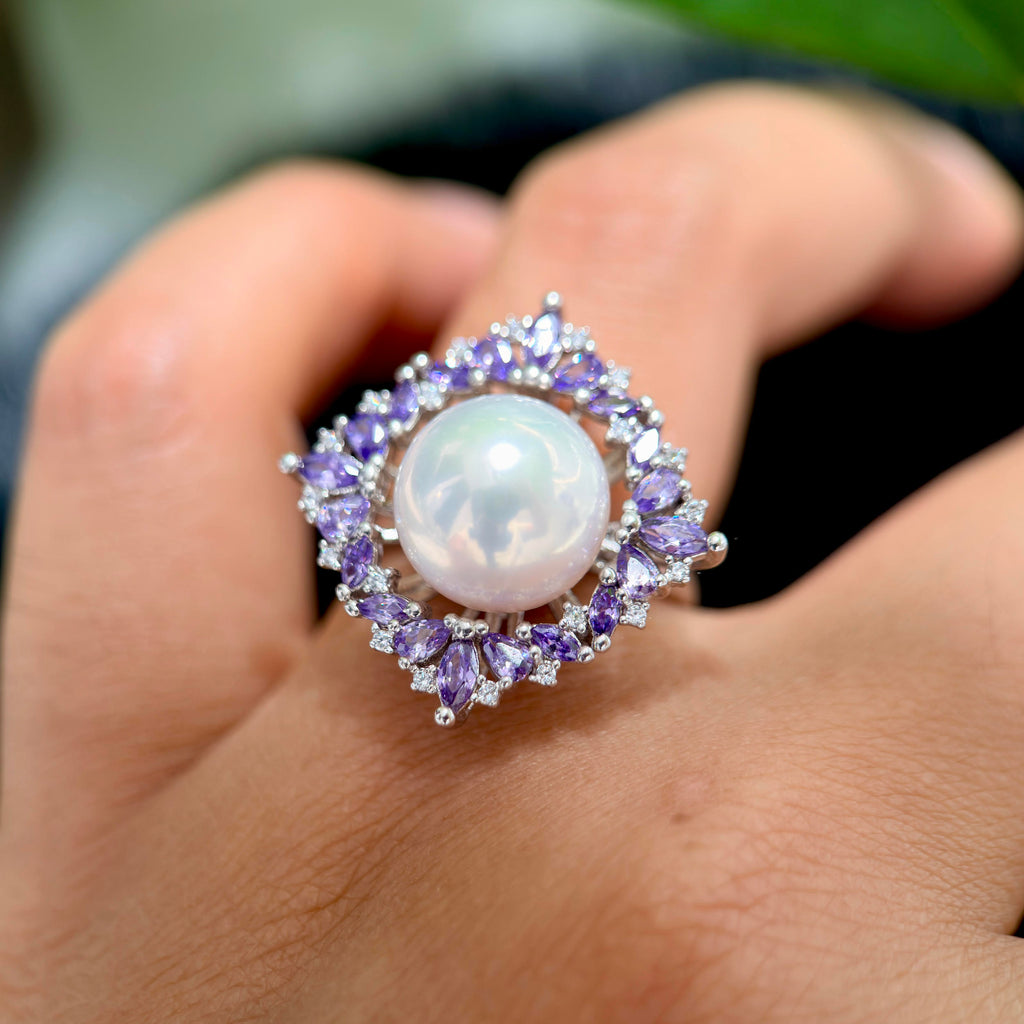White pearl crown ring with purple marquise zirconia accents.