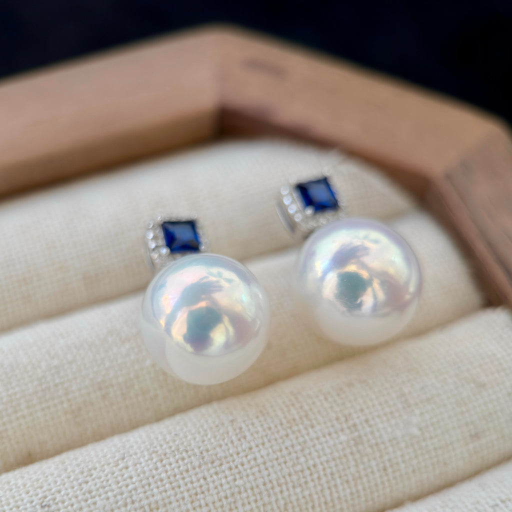 11.2 mm natural freshwater pearl drop earrings with blue accents.