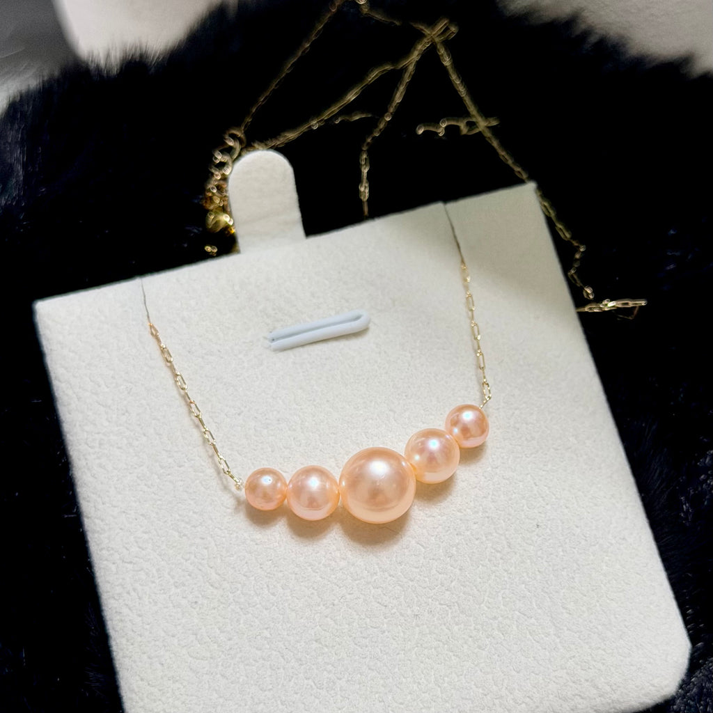 Golden-orange gradient freshwater pearl necklace on a sterling silver chain.