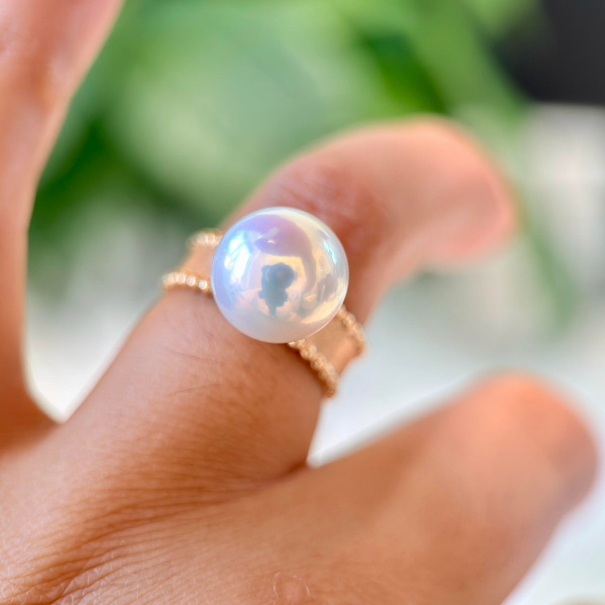 White pearl ring with blue and soft pink iridescent overtones.