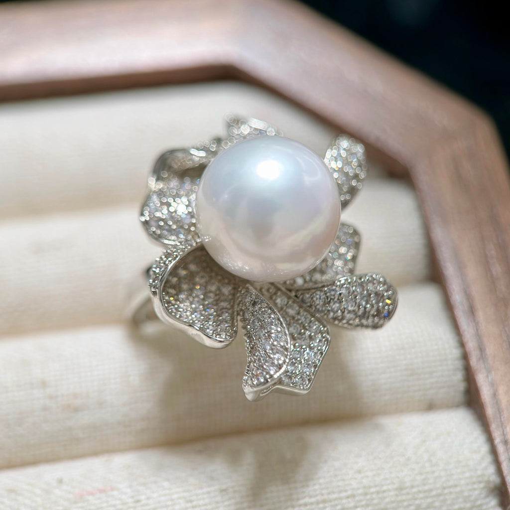 Large white pearl ring with sparkling floral silver-plated setting.