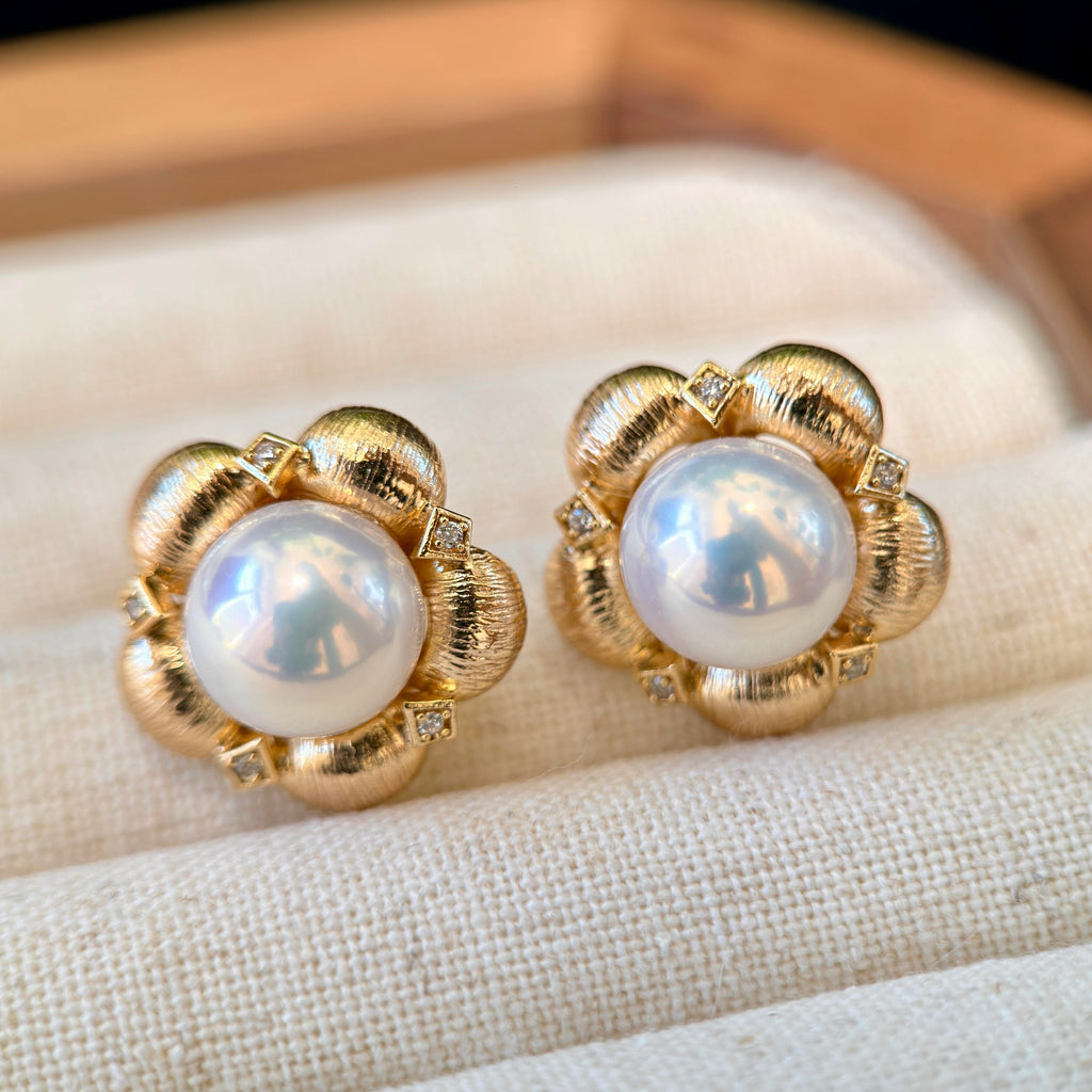 Vintage gold floral pearl earrings with sparkling accents.