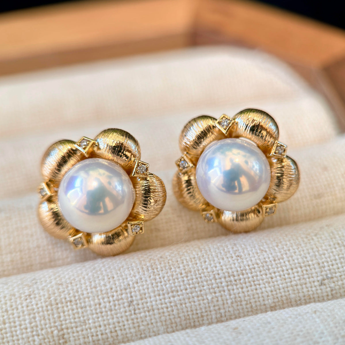 Vintage gold floral pearl earrings with sparkling accents.