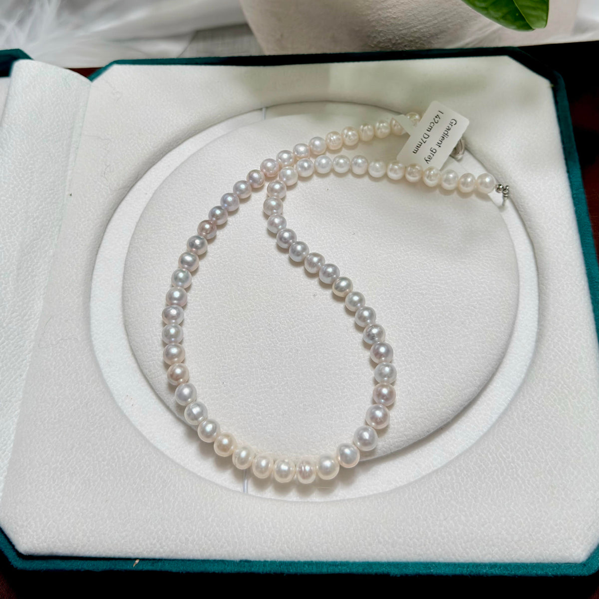 Grey-to-white freshwater pearl strand with subtle colour variation.