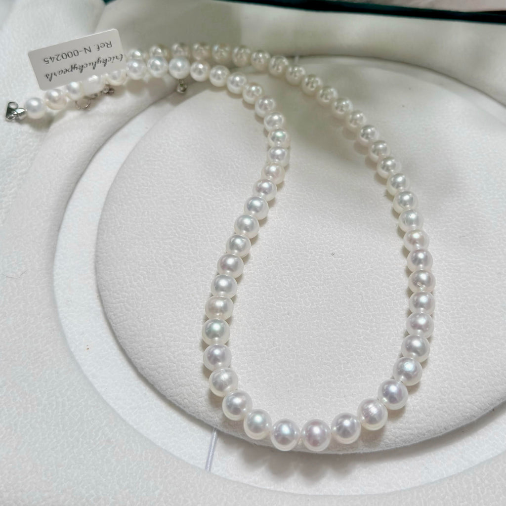 Classic single-strand freshwater pearl necklace in cool white with vivid blue iridescence.