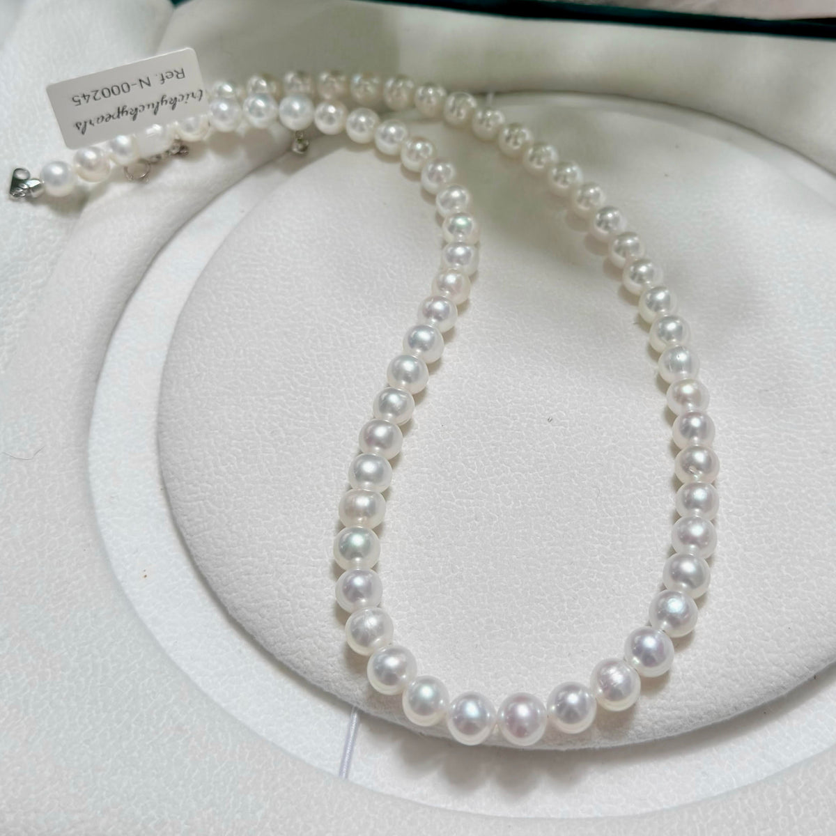 Classic single-strand freshwater pearl necklace in cool white with vivid blue iridescence.