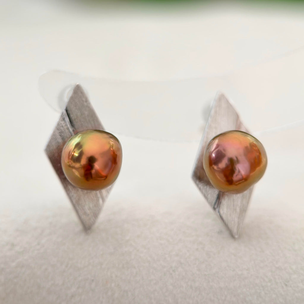 Reddish-brown baroque pearl earrings with subtle green overtones and brushed silver setting.
