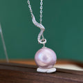 14.5 mm pale purple freshwater pearl necklace with sterling silver serpentine detail.