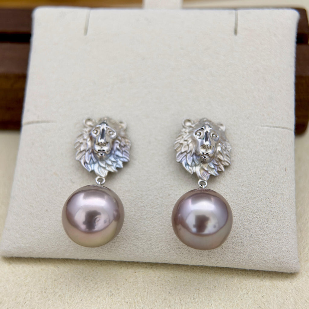 Lion pearl drop earrings with a vintage-inspired statement look.
