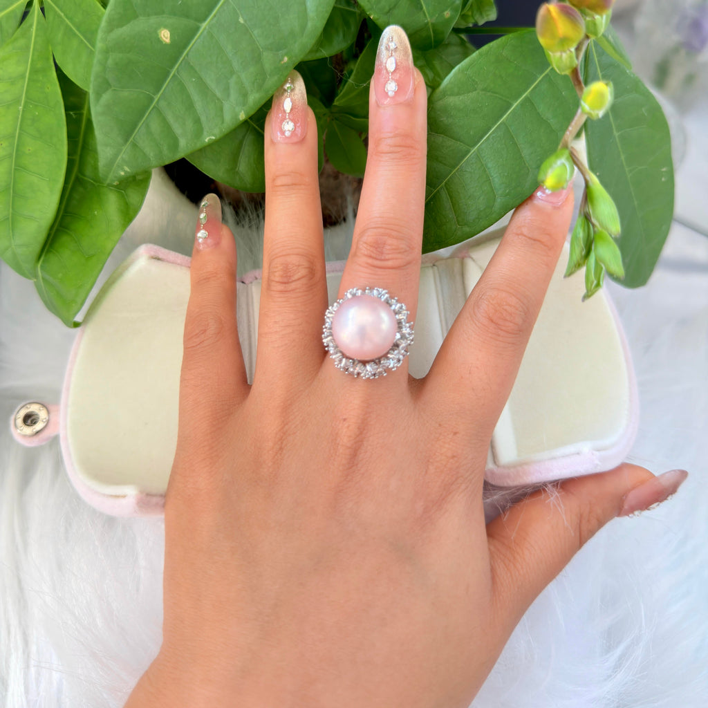 Romantic pink pearl statement ring with adjustable band.