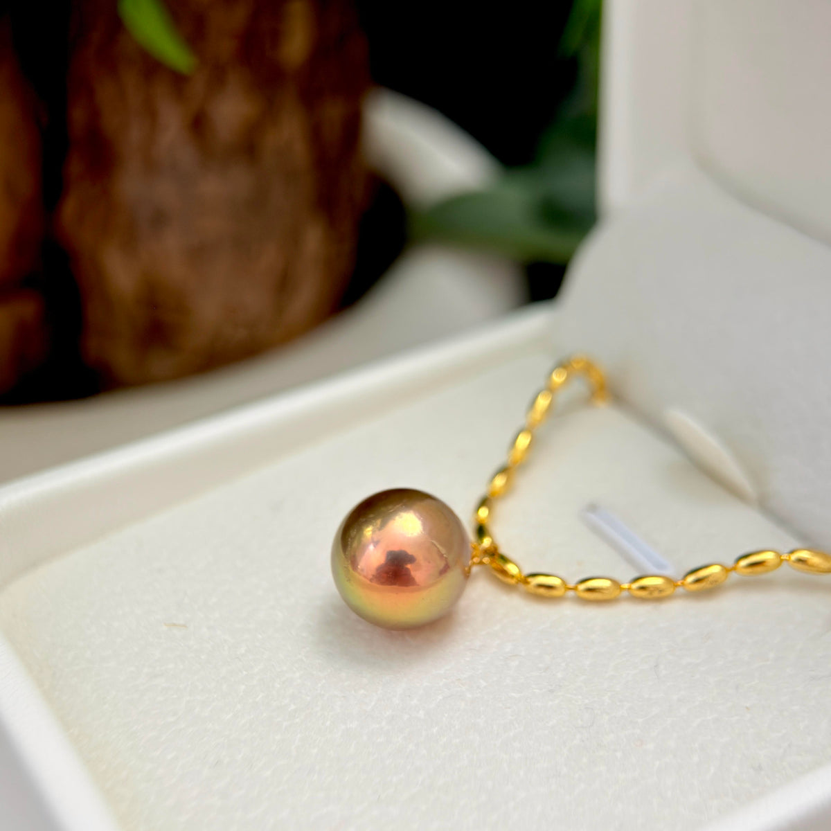 Brown, green and golden pearl necklace with artistic statement styling.