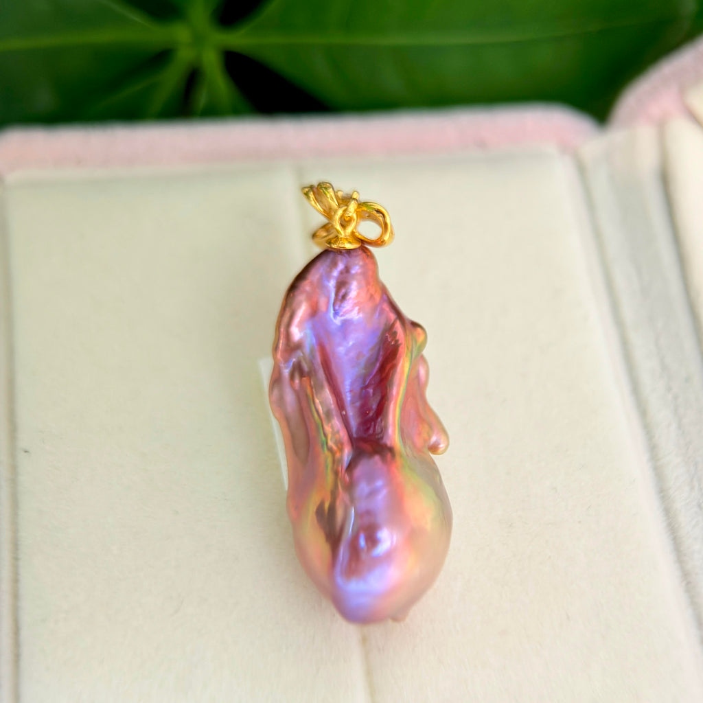 Multicolor baroque freshwater pearl pendant with sculptural iris flower in sterling silver.