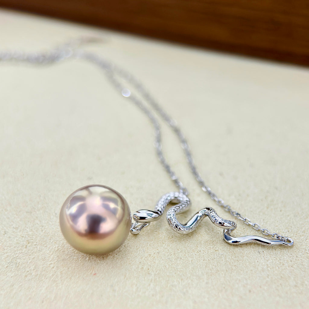 Modern snake pearl necklace with artistic statement styling.