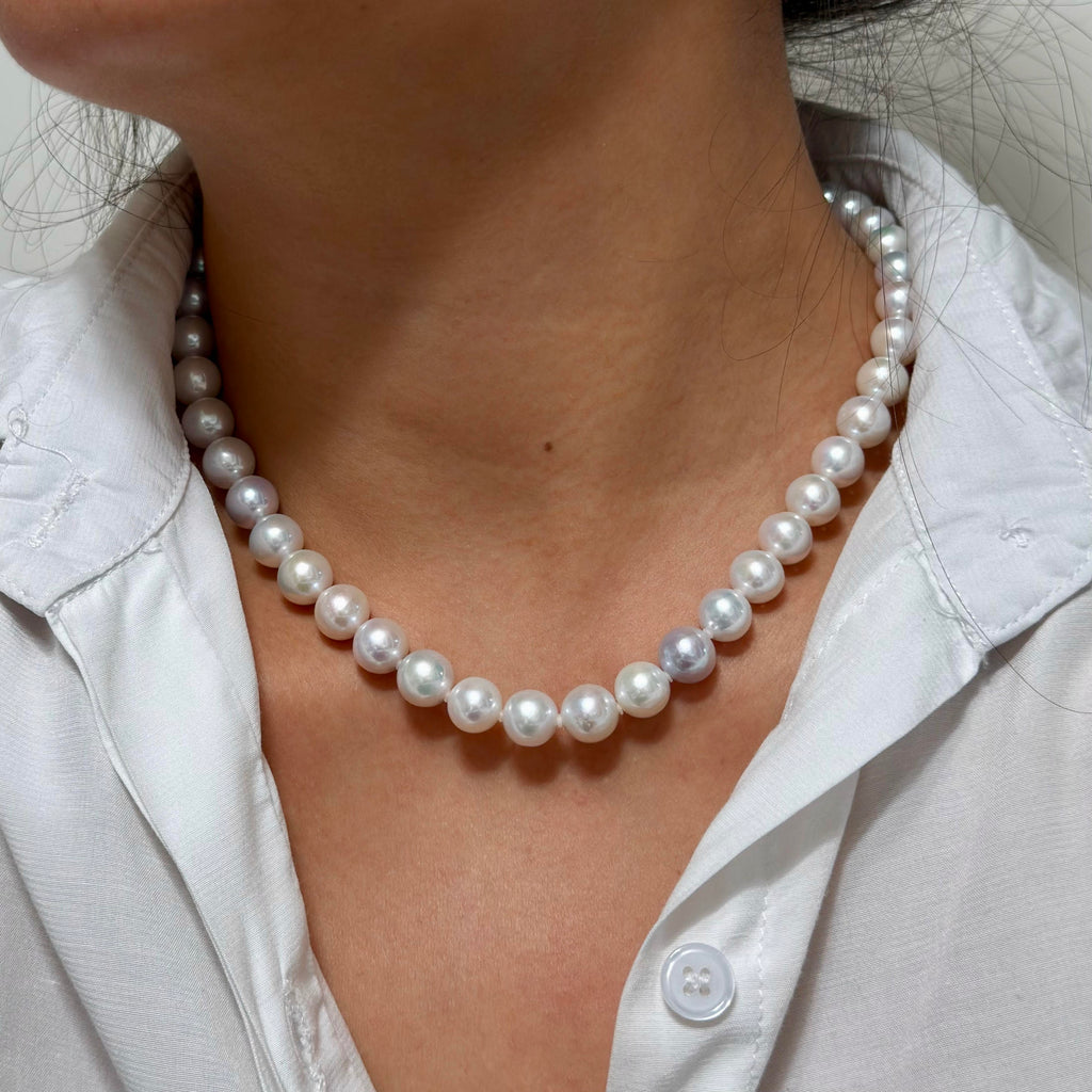 Close-up of 9–10 mm white with vivid blue and multicolour halo freshwater pearl necklace, 42 cm long.