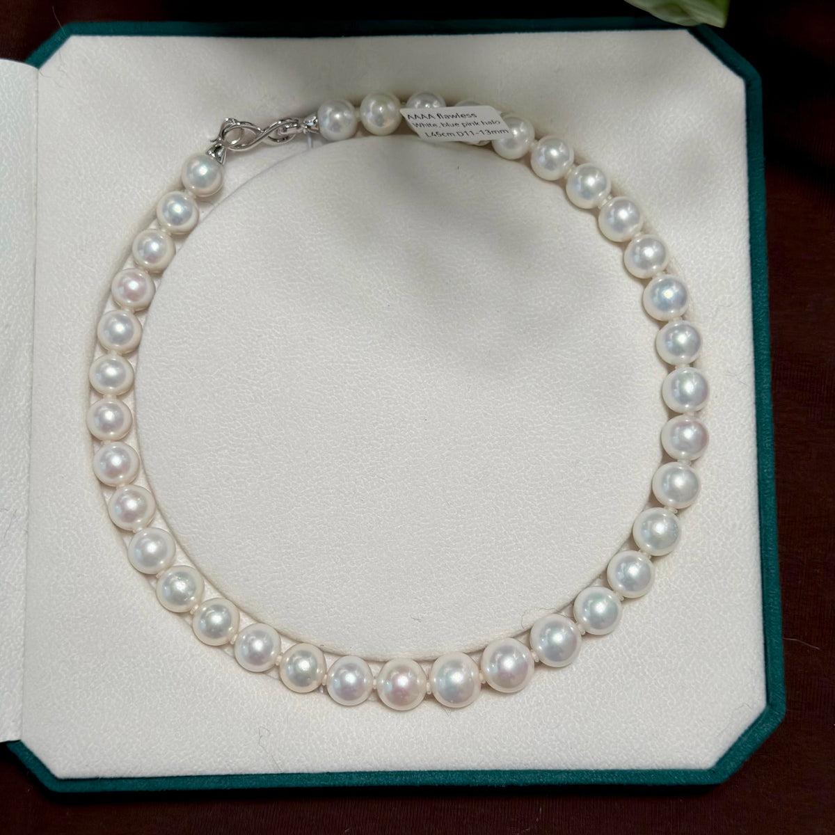 Detailed view of the lustre on this 11–13 mm freshwater pearl necklace.