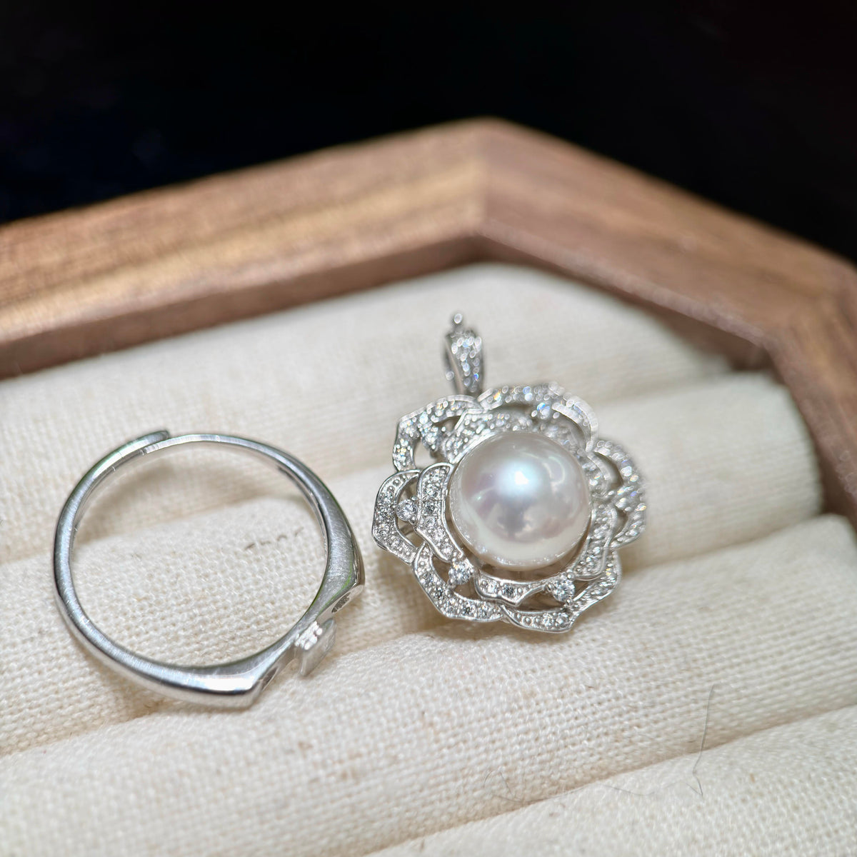 Sterling silver camellia flower jewelry designed to be worn as a ring or pendant.