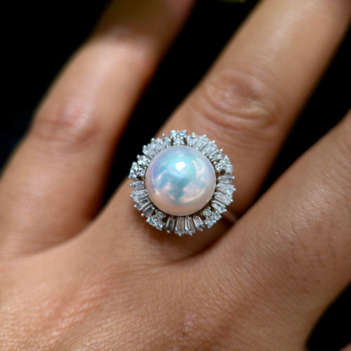 Elegant white pearl statement ring with bright halo design.