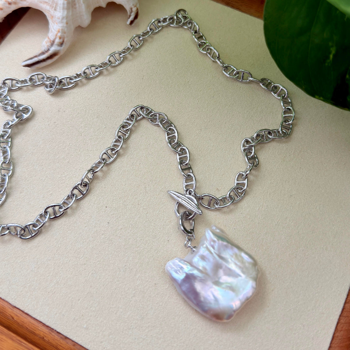 Iridescent halo detail on white square baroque freshwater pearl pendant on chunky white-gold-plated chain.