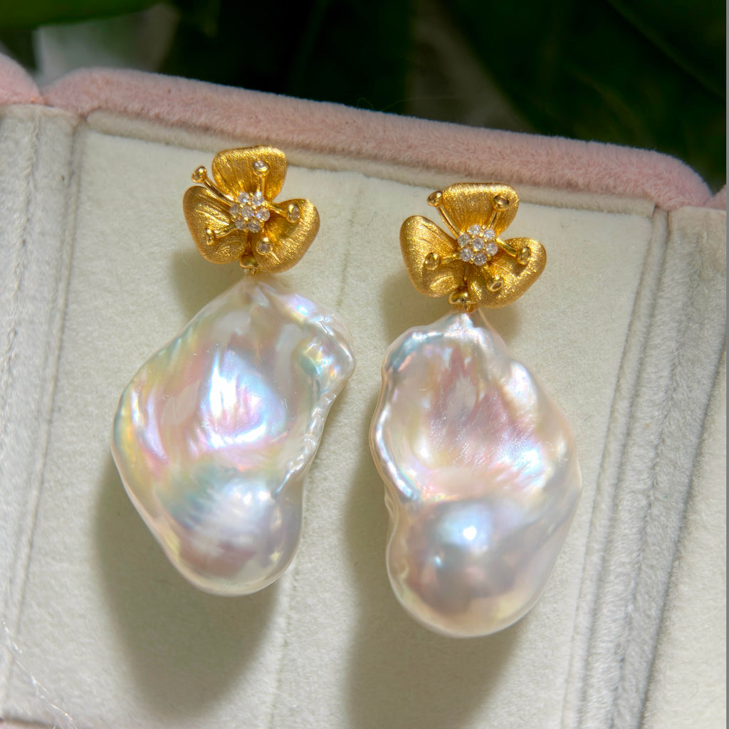 Detachable baroque pearl drop earrings with brushed flower studs.