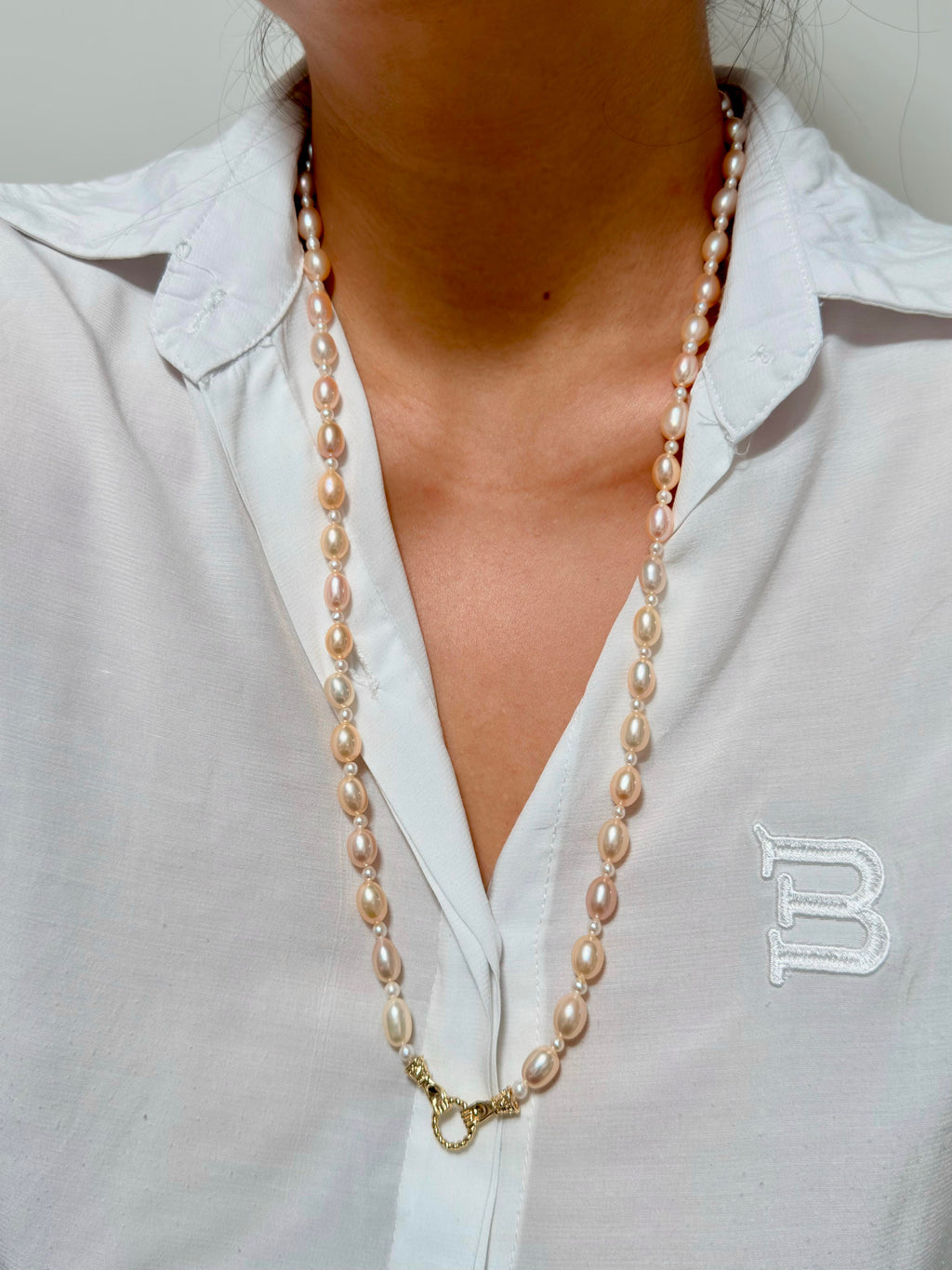 Elegant long pearl necklace styled as a statement piece.