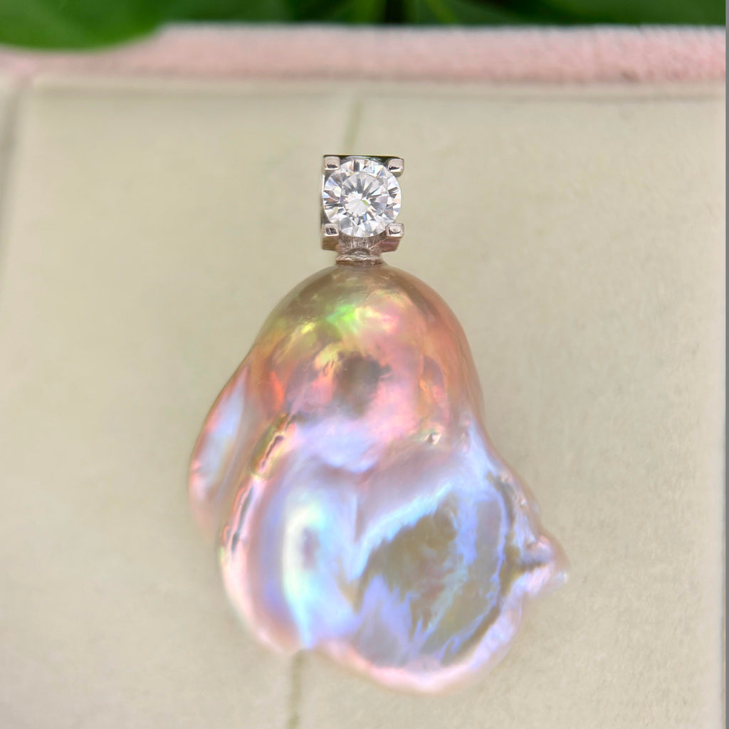 Freshwater pearl jewelry featuring whimsical blue baroque pearl pendant with colorful iridescent halo and silver setting.