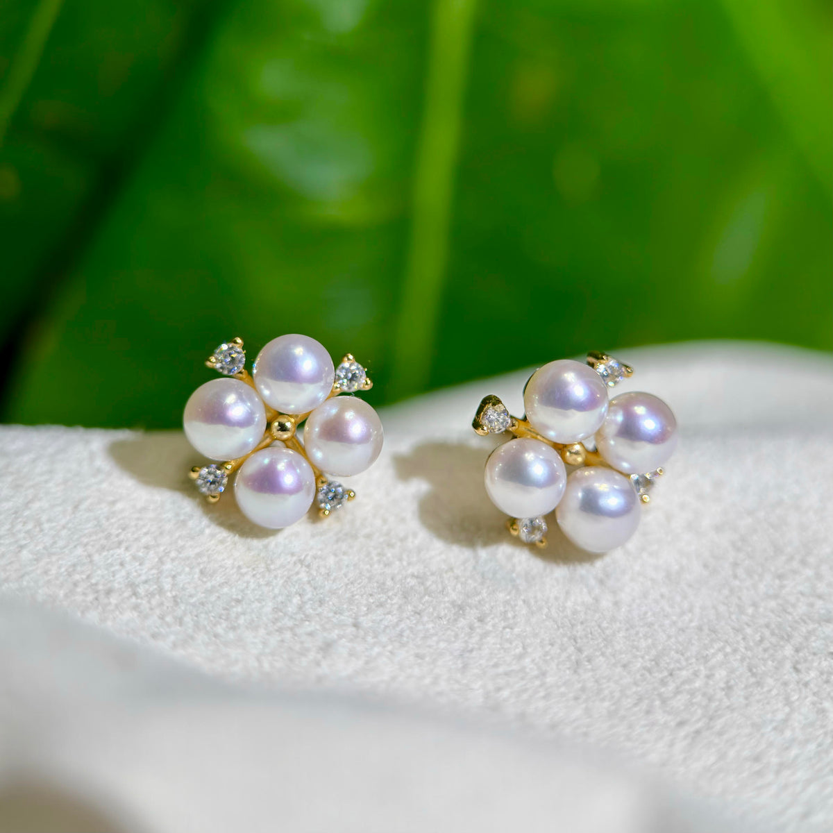 Delicate freshwater pearl stud earrings with a flower-inspired design.
