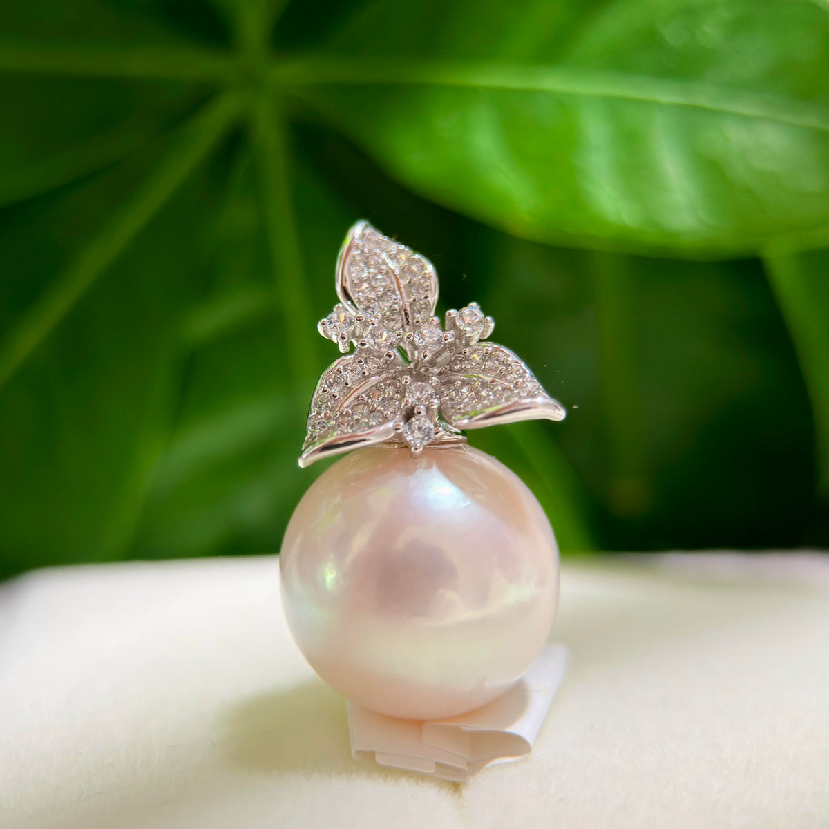 15 mm freshwater pearl pendant with a sparkling Bauhinia flower setting.