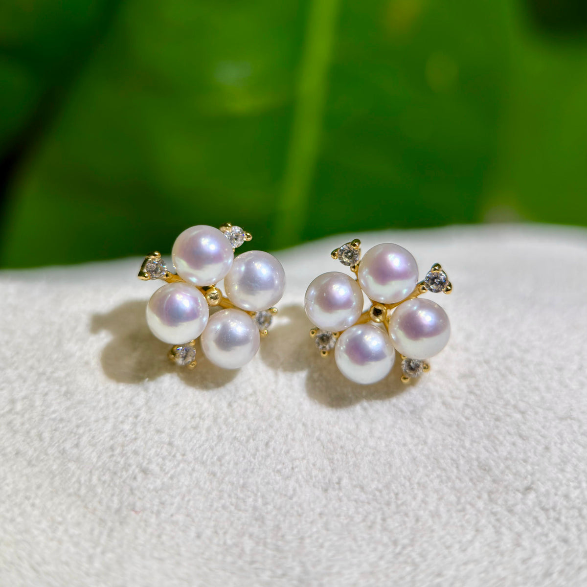 Feminine pearl earrings accented with small sparkling stones.
