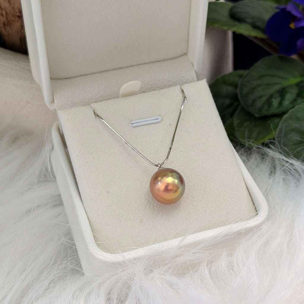 Minimalist single-pearl necklace styled for day-to-night wear.