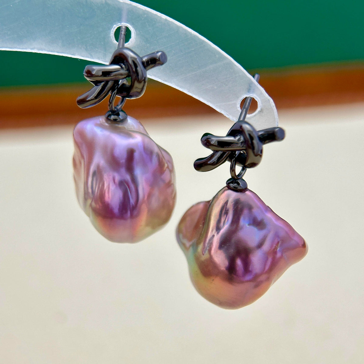 
Black knot pearl earrings with a bold contemporary jewelry design.