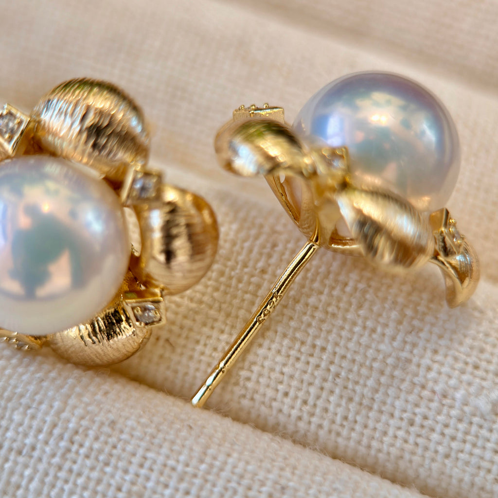 Mirror-lustre white freshwater pearl earrings in floral settings.