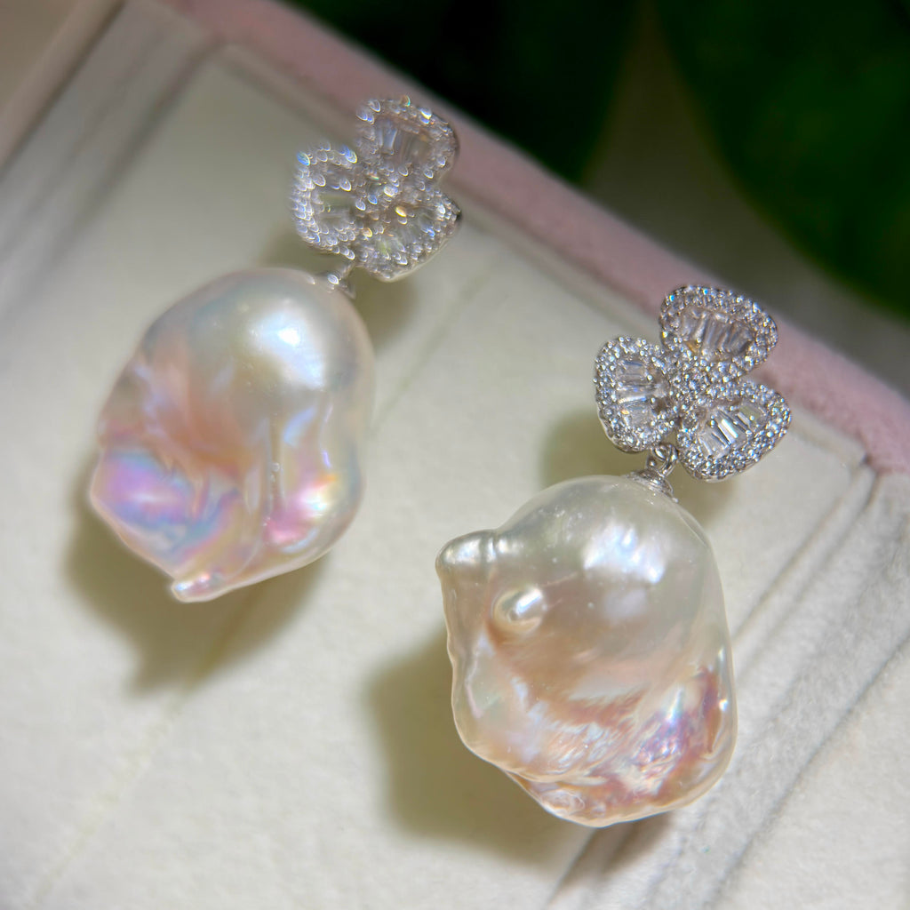 Cubic zirconia club pearl earrings designed as statement jewelry.

